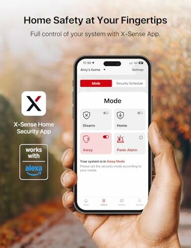 Hand holding smartphone showing X-Sense home security app interface.