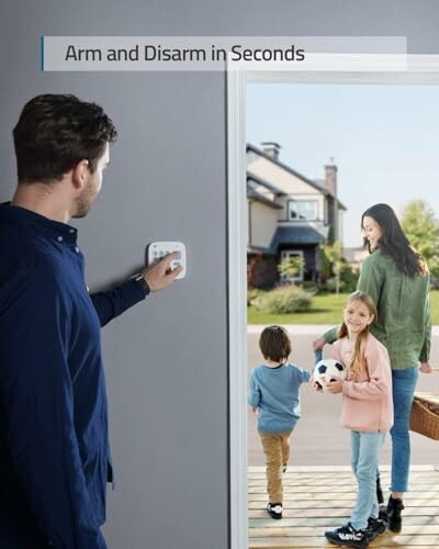 Man using security panel as family enters home