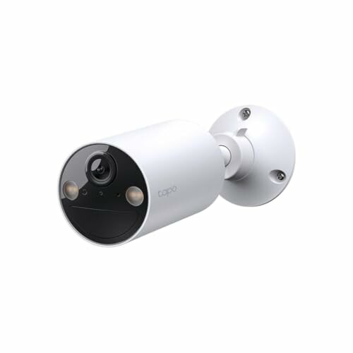 White outdoor security camera with wall mount.