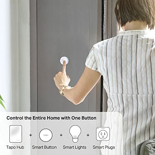 Person using a smart button to control home devices, including hub, lights, and plugs.