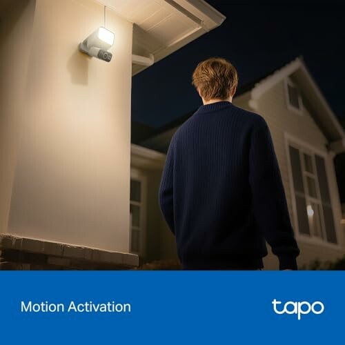 Person triggering motion-activated light at night.