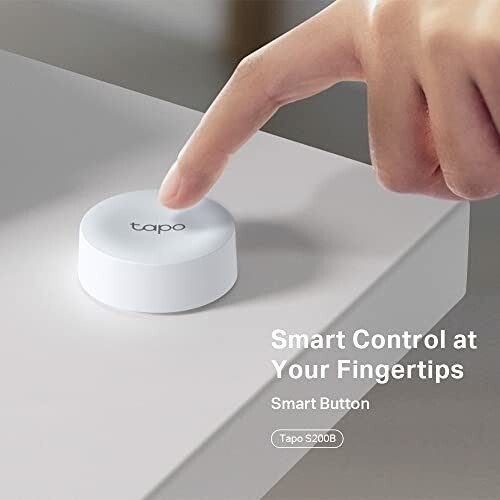 Hand pressing Tapo smart button on surface